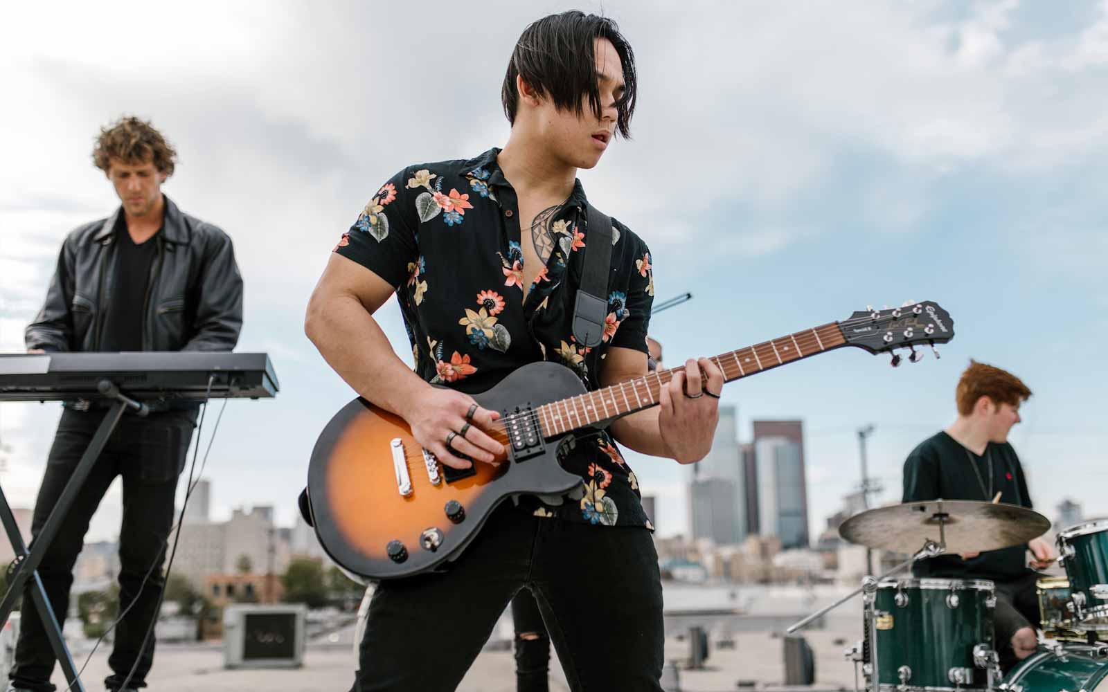 1 guitar playing tips, A guitarist playing a guitar with proper technique, guitar tips