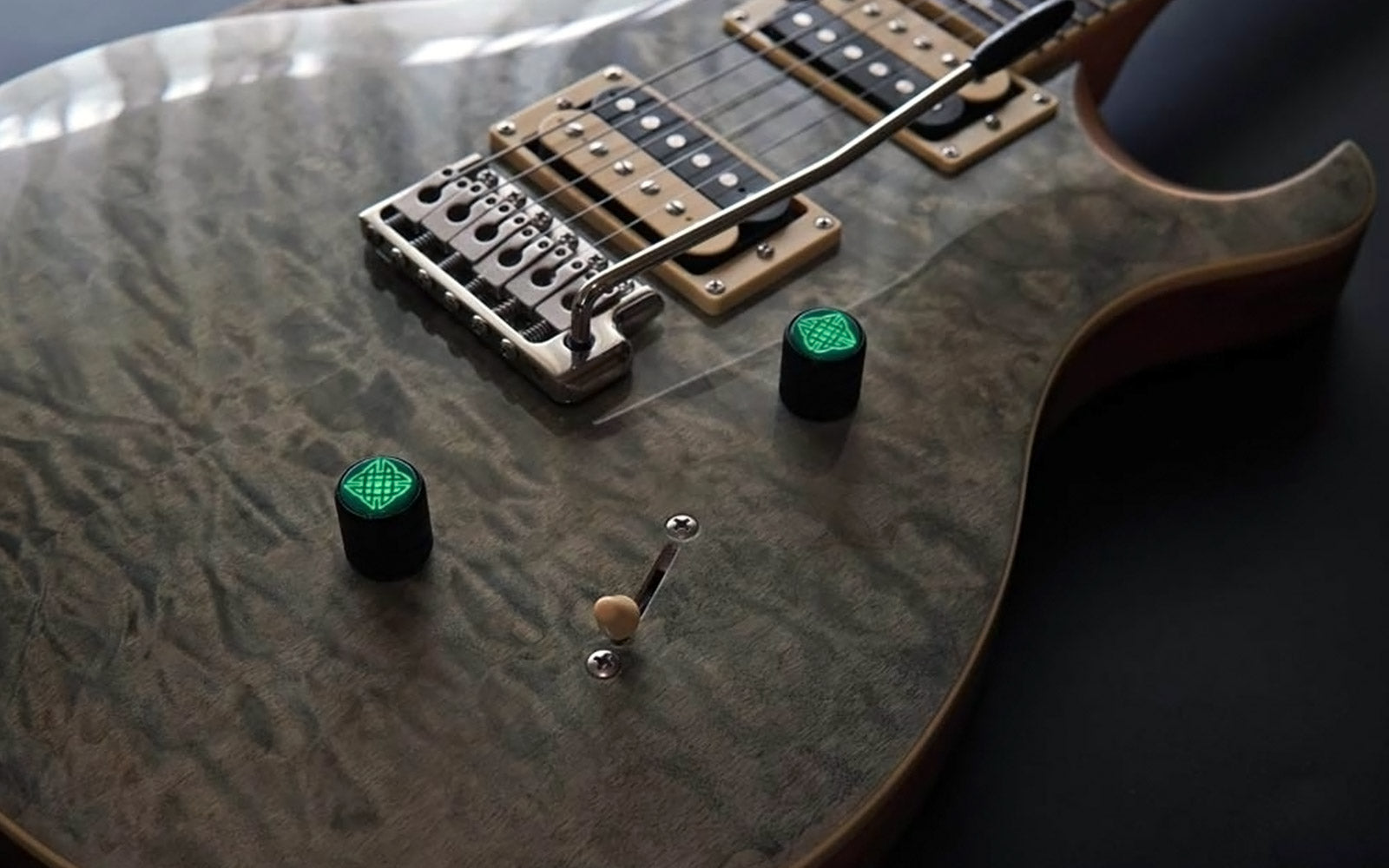 PRS guitar fitted with two Oisín pearl green guitar knobs featuring glowing engraved Celtic knot tops
