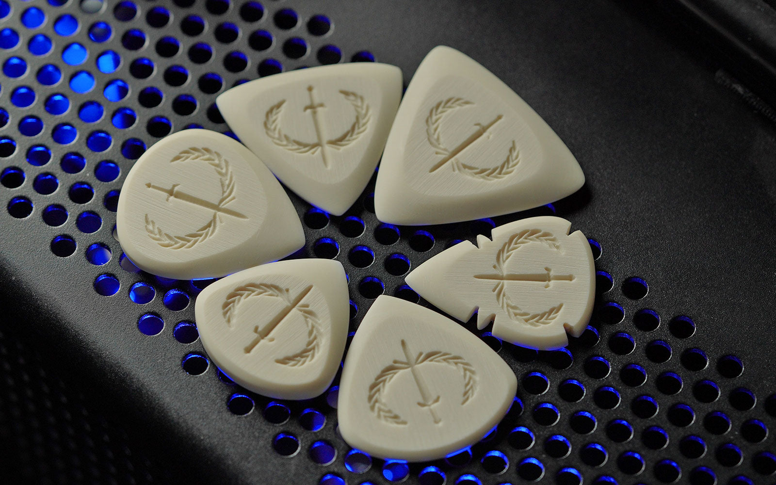 Synthetic ivory guitar picks from Iron Age Guitar Accessories displayed on a PRS MT-15 guitar amp
