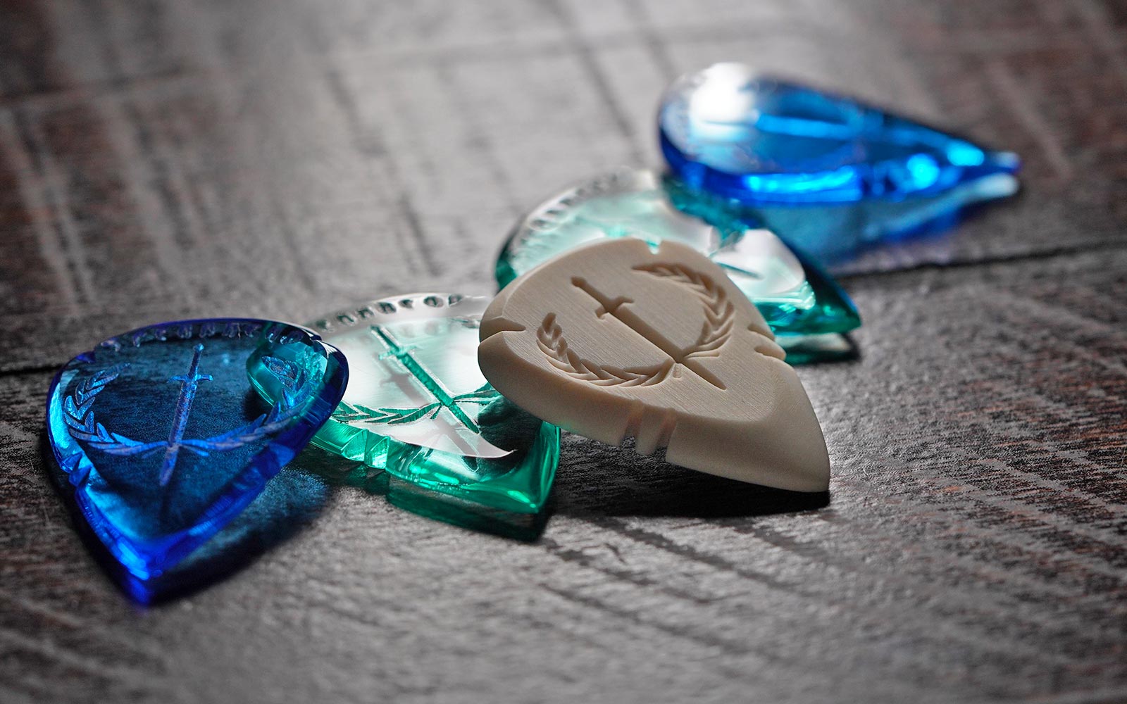 Iron Age teardrop guitar picks in acrylic and faux ivory Spearhead designs