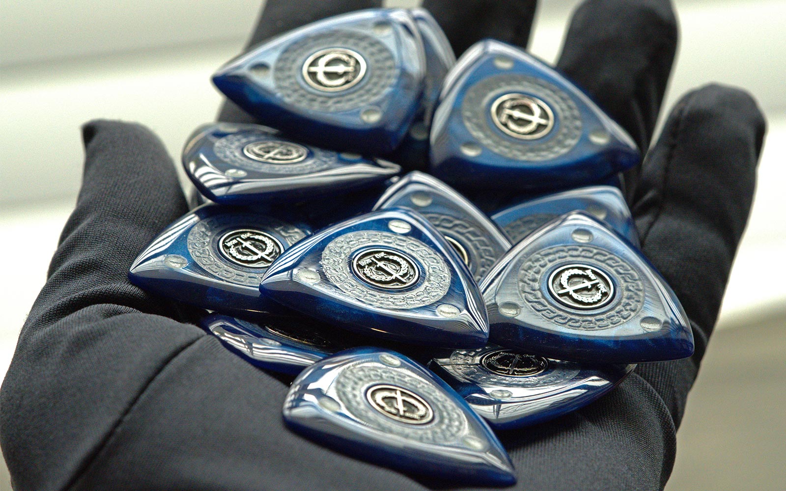 Handful of blue Iron Age Archon triangle guitar picks with three matching points