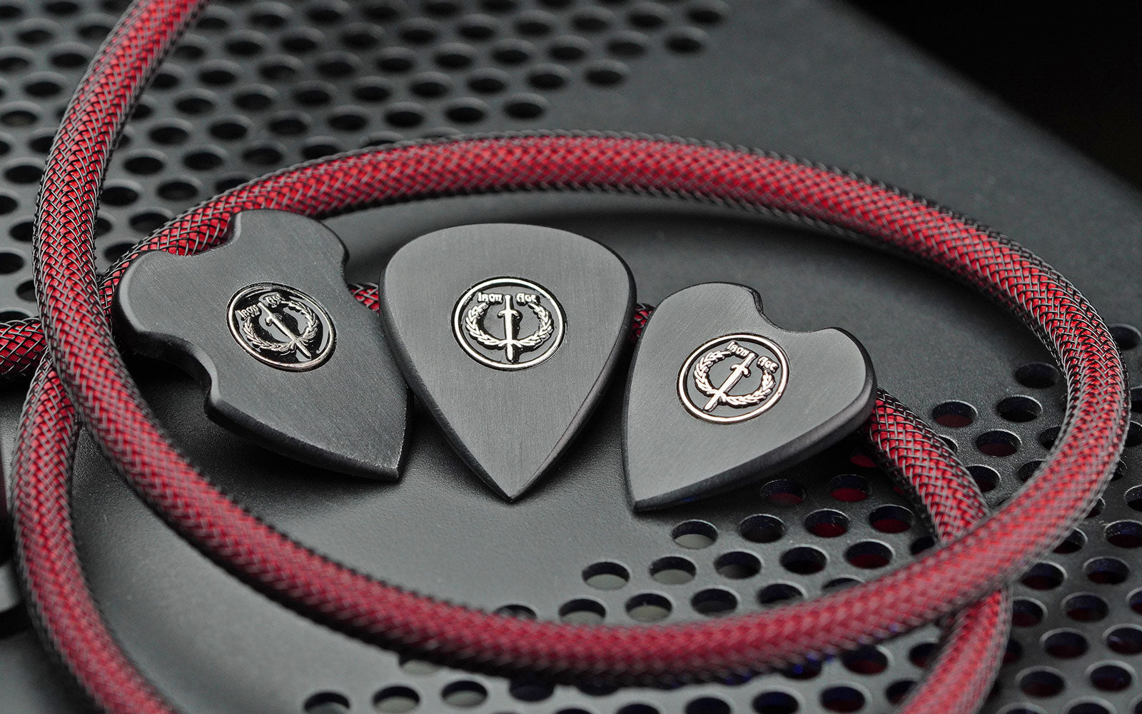 Black UHMWPE guitar picks from Iron Age Guitar Accessories in multiple shapes