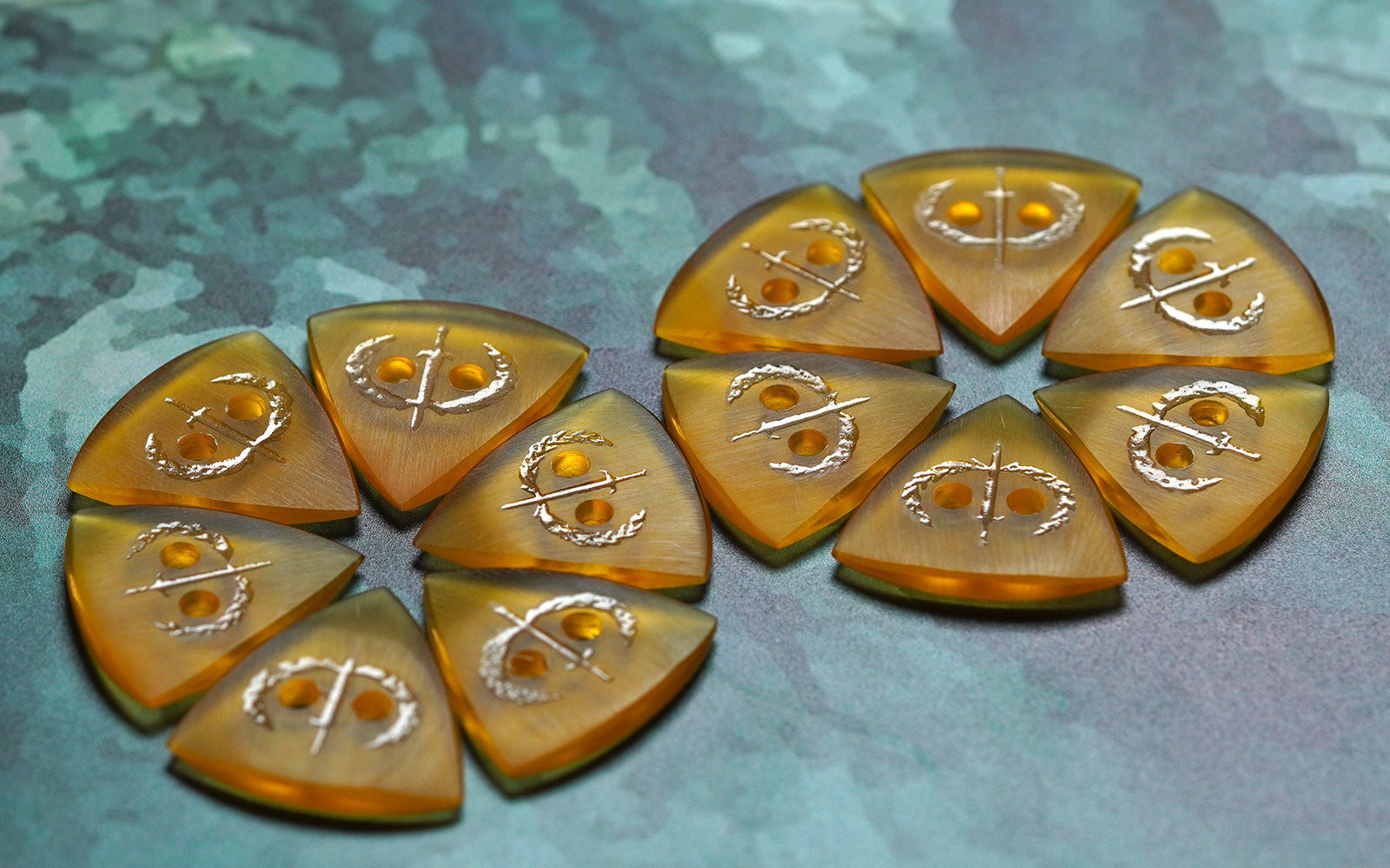 Amber Ultem guitar picks from Iron Age Guitar Accessories in multiple shapes and designs