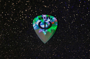 Guitar pick with a colorful design on a black background