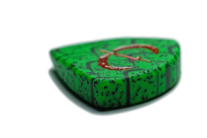 Angled view of 6mm Wyvern Edition Dragon Scale guitar pick with textured resin composite surface