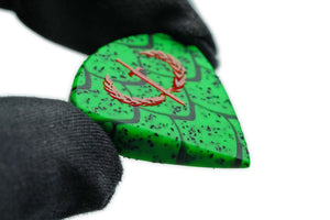 Wyvern Edition Dragon Scale guitar pick held by hand to show size, thickness, and grip texture